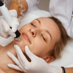 A cosmetologist performs hydropiling in a beauty salon. Skin care. A cosmetologist performs hydropiling in a beauty salon. Skin care. High quality photo